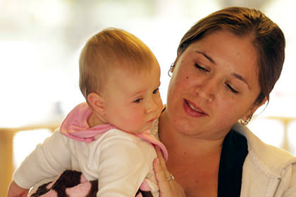 A mother holding her child.