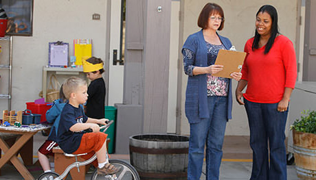A day care director discussing details with a teacher.