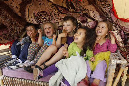 Five children laughing together.